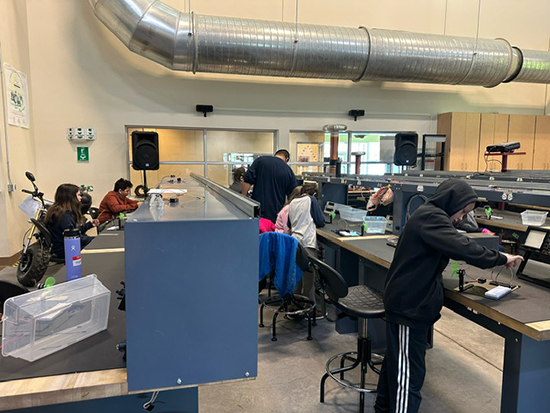 Students sitting and standing at lab tables in the Industrial technology Center.
