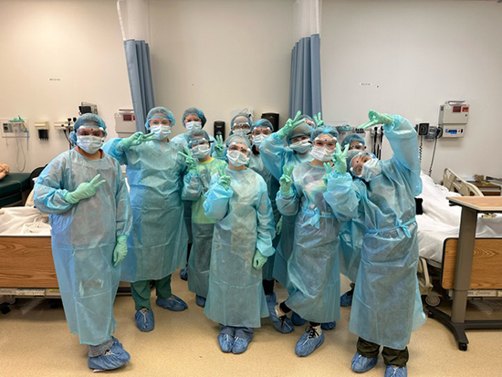 Nursing Exploration Project participants in a lab wearing healthcare worker gear.