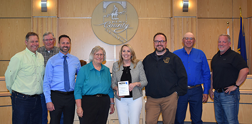 Photo: GBC's Dr. Amber Donelli, holding award poses with members of the Nevada Emergency Preparedness Association and Elko officials.