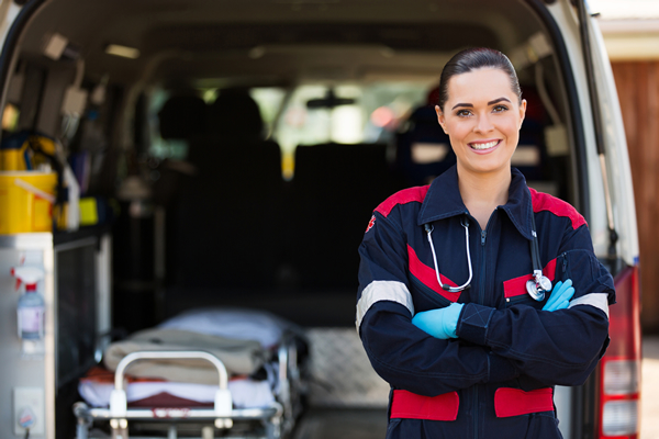 EMS Paramedic Female EMS Paramedic standing next to an ambulance.